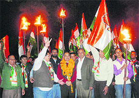 Congress candidate Mukesh Bassi takes out a torch march along with supporters at Sector 18. 