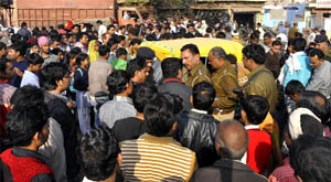 People gather at the spot where a 12-year-old girl died when a dumper hit her cycle near SGM Nagar in Faridabad. 