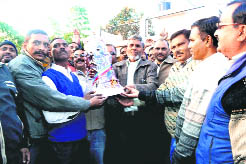 Employees of the Revenue Department felicitate state Revenue Minister Diwakar Bhatt at his Tarun Himalaya residence in Haridwar on Wednesday.