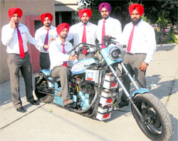 BTech mechanical engineering students of CT Institute demonstrate the hybrid bike in Jalandhar on Wednesday