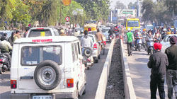 Traffic gets disrupted as lecturers of non-government colleges take out a rally at a busy intersection near the General Post Office in Jalandhar on Wednesday
