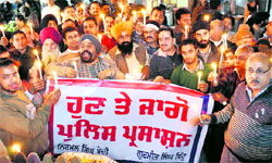 Shopkeepers of the Panj Peer market take out a candlelight march in Jalandhar on Wednesday