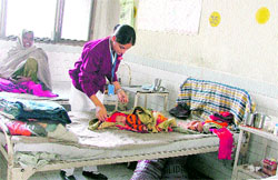 With nurses on strike, an intern takes care of a child at Lord Mahavir Civil Hospital in Ludhiana