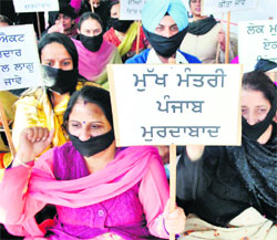 Pharmacists stage a protest during Deputy Chief Minister Sukhbir Badal's visit to Patiala on Wednesday
