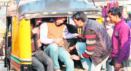 Tourists board an overloaded auto-rickshaw from the Jallianwala Bagh point to reach the Wagah-Attari joint checkpost to watch the Beating the Retreat ceremony in Amritsar.