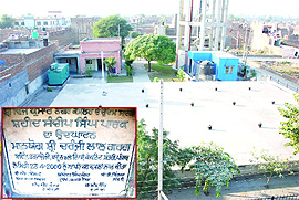 The park set up in the memory of a Kargil martyr, Sandeep Singh, in Paras Ram Nagar now houses a water tank much to the dismay of his parents; The foundation stone (inset) that was laid in 2000 by the then Punjab minister Chiranji Lal Garg. 