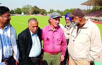 (From left) KK Mittal, XEN, Sports Department, Choutas, a member of the German team executing the project for laying the astro turf and ex-Olympian SS Grewal during the pre-inspection exercise of the turf at the Rajindra College in Bathinda on Thursday.