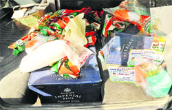 Cartons of liquor along poll material of a Congress candidate in a Maruti van at Sector 36 in Chandigarh on Thursday