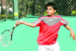 Karandeep makes a forehand return during a semifinal match of the boys u-16 category at the CLTA courts in Chandigarh on Thursday