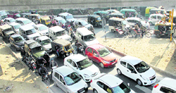 Following a protest by lecturers of non-government colleges, vehicles stuck in a traffic jam on one of the roads in Jalandhar on Thursday.