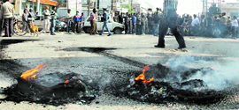 Burnt tyres after residents of Model House held a protest against construction of a road divider in Jalandhar on Thursday.