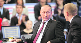 Russian PM Vladimir Putin speaks during a televised questions and answers session.