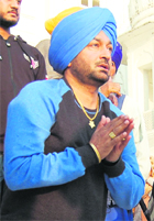 Malkiat Singh pays obeissance at the Golden Temple in Amritsar on Friday. 