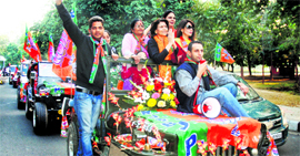 BJP supporters hold a car rally in support of party candidate Satinder Dhawan on the road separating Sectors 9 and 10, Chandigarh, on Friday.