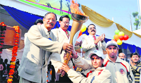 Chief Minister B.C.Khanduri presents a torch to athletes to mark the opneing of the All-India Forest Sports meet at the FRI in Dehradun on Friday.