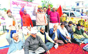 Communist Party of India (CPI) activists hold a rally to demand the Food Security Act in Haridwar on Thursday.