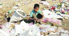 A child looks for useful items in garbage in the Shakti Nagar area of Jammu.