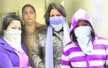 The accused women (faces covered) in police custody in Ludhiana on Friday. 