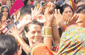 Congress president Sonia Gandhi dances with tribal women during the national convention on Empowerment to Tribal Women at the AICC office in New Delhi on Friday
