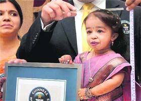 Jyoti Amge, the worlds shortest living woman, with her Guinness World Records certificate, on her 18th birthday in Nagpur on Friday