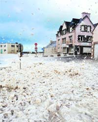 Thick foam is seen at the French harbour of Saint-Guenole during a severe storm on Friday, which left nearly 4 lakh households without electricity and wreaked havoc on train traffic