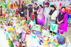 Parents of schoolchildren view items at the Art and Craft exhibition at Senior Study School in Amritsar on Saturday.