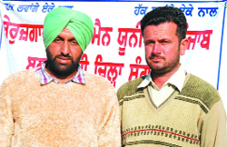 Daler Singh (left) and Angrej Singh who lost their jobs due to their participation in an agitation by the Unemployed Linemen Union, Punjab. 
