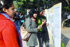 Girls admire photos on display at Click Rights, an exhibition to highlight the poor state of schools in New Delhi on Saturday. 