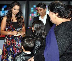 Tennis player Sania Mirza gives autographs to her fans at a function in Ambience Mall, Gurgaon