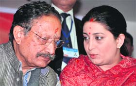 Chief Minister BC Khanduri having a word with BJP National Womens Wing president Smriti Irani in Dehradun on Saturday