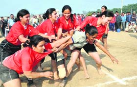 Himachal teammates (red) grapple with a Gujarat player (blue) in a kabaddi match at the 19th All-India Forest Sports Meet in Dehradun on Saturday