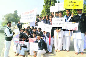 Students hold placards at Vishwakarma Ghat as part of the Ganga Sparsh Abhiyaan in Haridwar on Saturday.