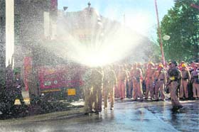 Fire-fighters conduct a mock drill, at the BSNL building in Shimla on Saturday