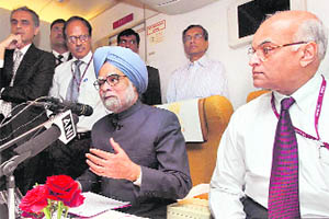 Prime Minister Manmohan Singh with NSA Shiv Shankar Menon addresses mediapersons onboard his special aircraft to New Delhi on Saturday after his Russia visit. 
