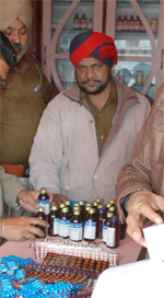 Police personnel inspect medicines at a medical store in Jalandhar on Saturday.
