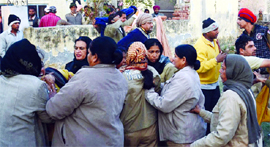 Police personnel control the mob following tension in the ancient Ram Tirath Temple near Amritsar on Sunday.