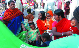 Migrant workers buy stuff at the Sunday market on the Amrik Singh road.