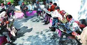 As poll fever catches up, people intently read the newspapers at the Public Library while soaking in the winter sun to keep abreast of the latest developments during the weekend in Bathinda.