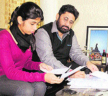 Congress candidate Pradeep Chhabra calculates the number of votes cast at his residence in Chandigarh on Sunday