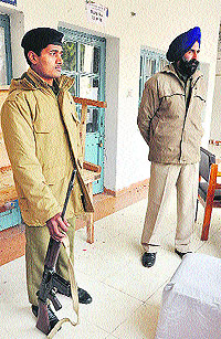 Policemen gaurd the strong room where EVMs are placed at a counting centre in B.ed College, Sector 20, Chandigarh, on Sunday