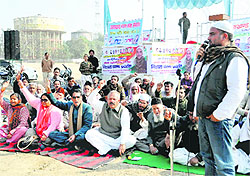 Congress workers hold a protest against the state BJP government at the Parade Ground in Dehradun on Sunday