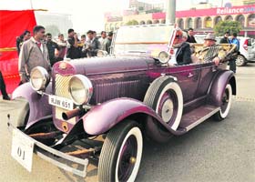 People take part in a vintage car rally organised by the Heritage Motoring Club of India in Gurgaon on Sunday