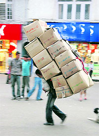 A labourer carries goods on his back in Shimla