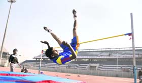 Manpreet Singh takes part in a long jump event during the Punjab School Games in Ludhiana