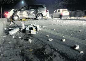Debris lies scattered after a Toyota Innova hit two vehicles on the Ferozepur Road