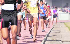 Athletes run barefoot in a race during the Punjab School Games at Guru Nanak Stadium, Ludhiana