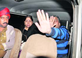 Toyota Innova driver Neeraj Vij tries to cover his face from the camera after the accident
