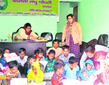 Volunteers of the Ayushman Social Welfare Society teach the children of slum colonies at Kankhal in Haridwar on Monday. 