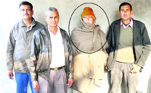 Ziledar Mohinder Pal (encircled) after he is caught by the State Vigilance Bureau while accepting bribe from a farmer at Fatehabad on Monday. 