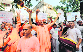 ISKCON followers hold placards during an agitation in front of the Russian Consulate in Kolkata on Monday